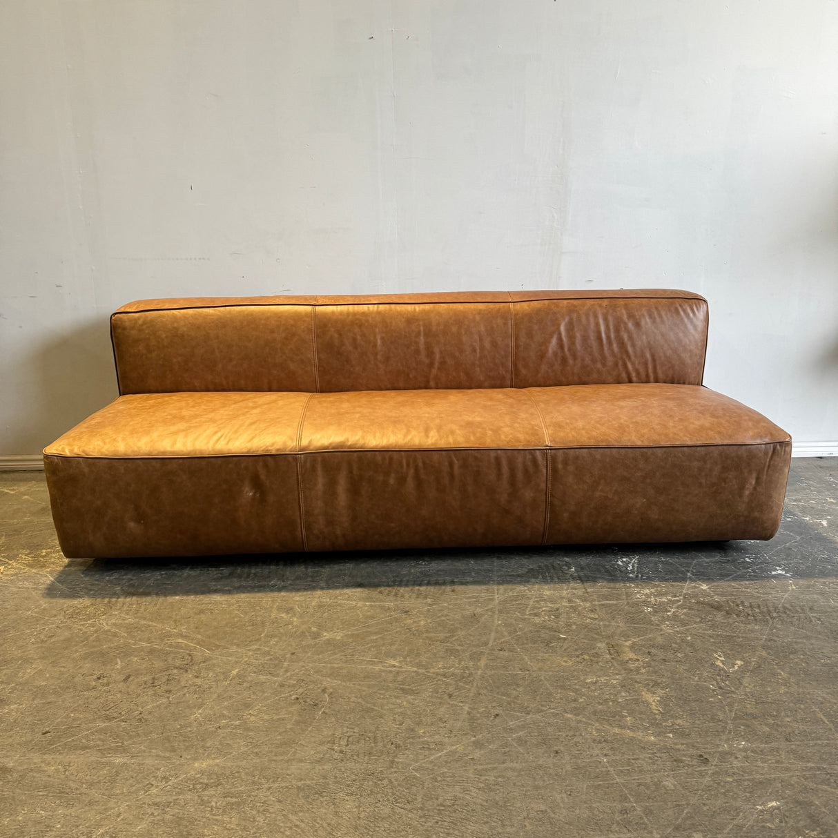 CB2 Lenyx Saddle Leather Armless Sofa